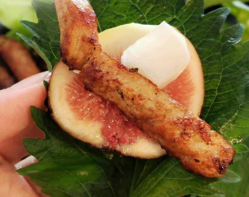 Perilla leaf wrap with a fig slice, grilled pork and pickled radish